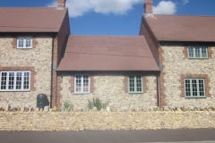 Medium Faced Flint Stone House with Large Faced Flint Stone Wall