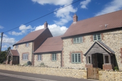 Medium Faced Flint Stone Houses with Large Faced Flint Stone Wall