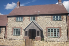 Medium Faced Flint Stone House with Large Faced Flint Stone Wall