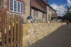 Large Faced Flint Stone Wall with Medium Faced Flint Stone House