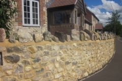 Large Faced Flint Stone Wall with Medium Faced Flint Stone House